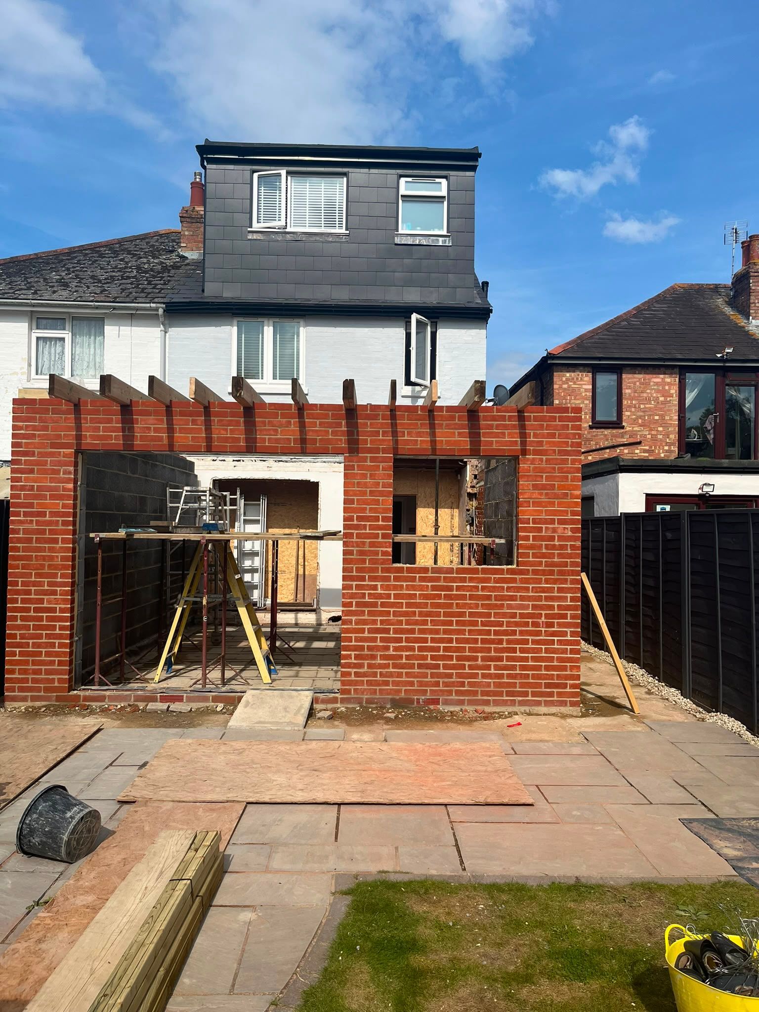 Red bricks have been installed with roof timbers being laid in preparation for rubber roof