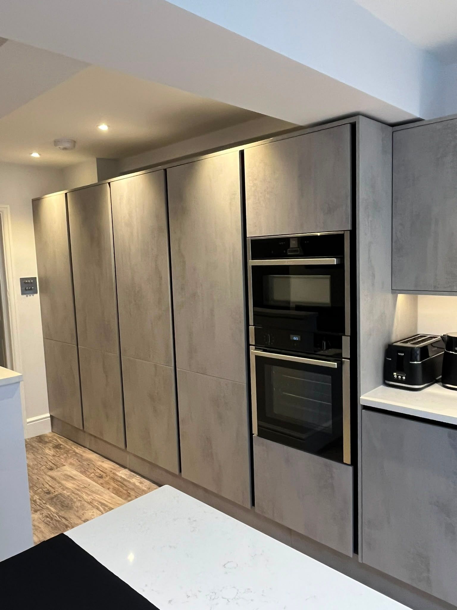 Row of cupboards and integrated fridge, oven and microwave in Old Windsor