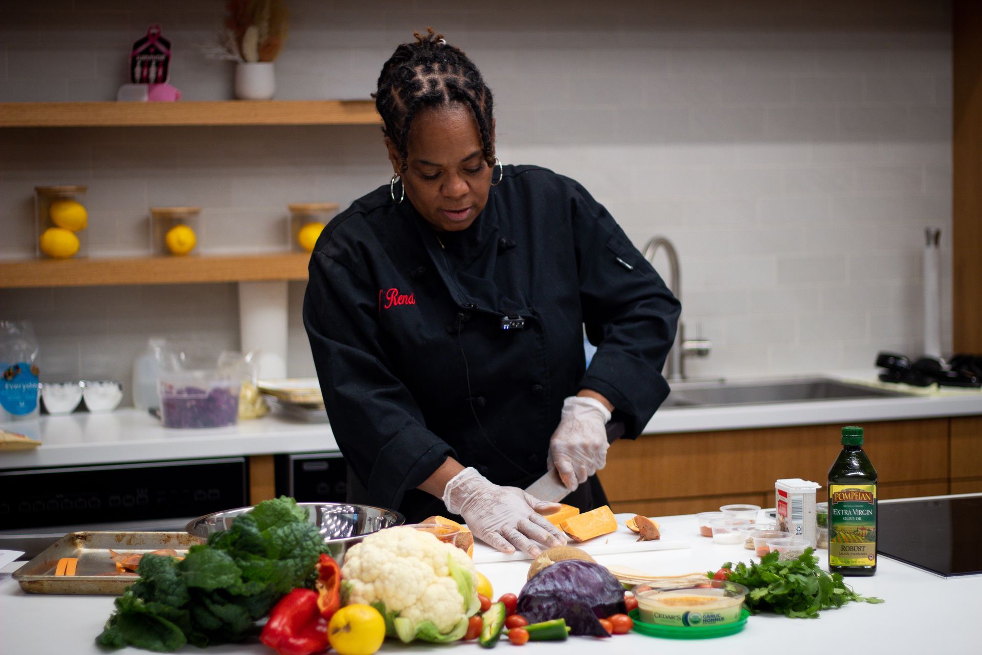 A woman is sitting at a bar preparing  food.