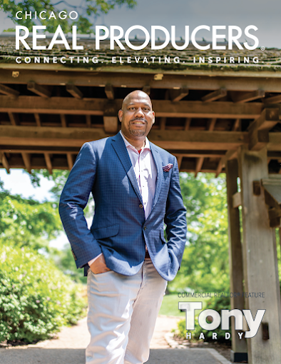 Magazine cover: Man in blue blazer stands at a garden archway. The magazine title is