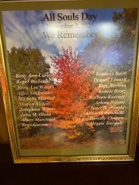 Framed All Souls Day memorial poster with autumn tree and names on a reflective glass background