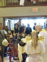 People in costume gathered at a church entrance during a community event