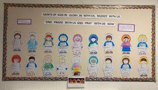 Bulletin board with colorful paper character crafts and a Bible verse about singing praise to God.