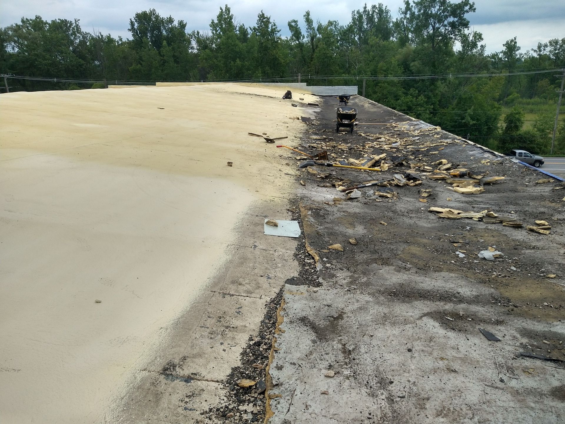 A dirty roof with a few trees in the background