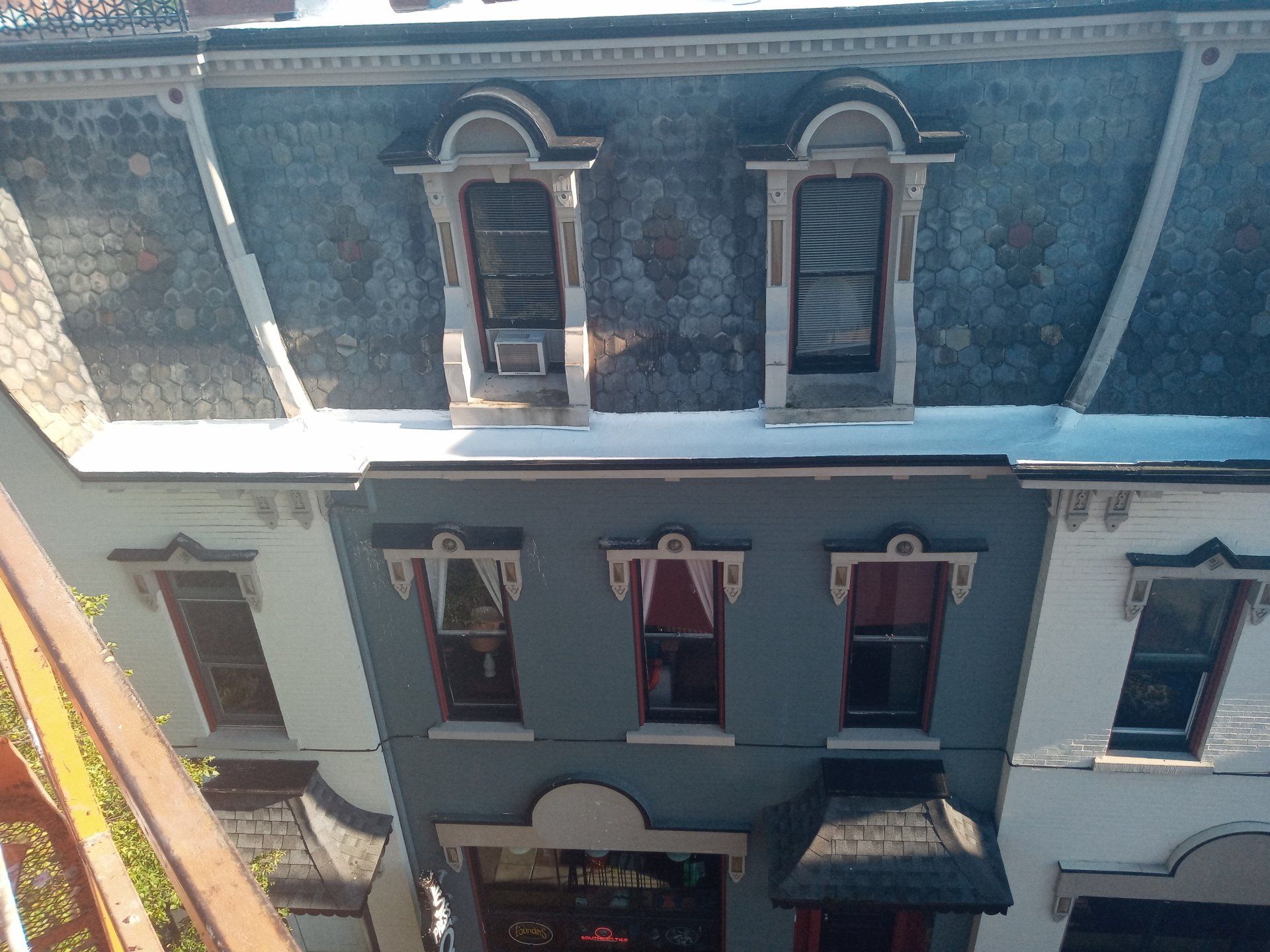 An aerial view of a building with a blue roof