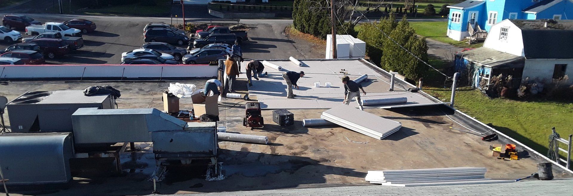 A group of people are working on the roof of a building