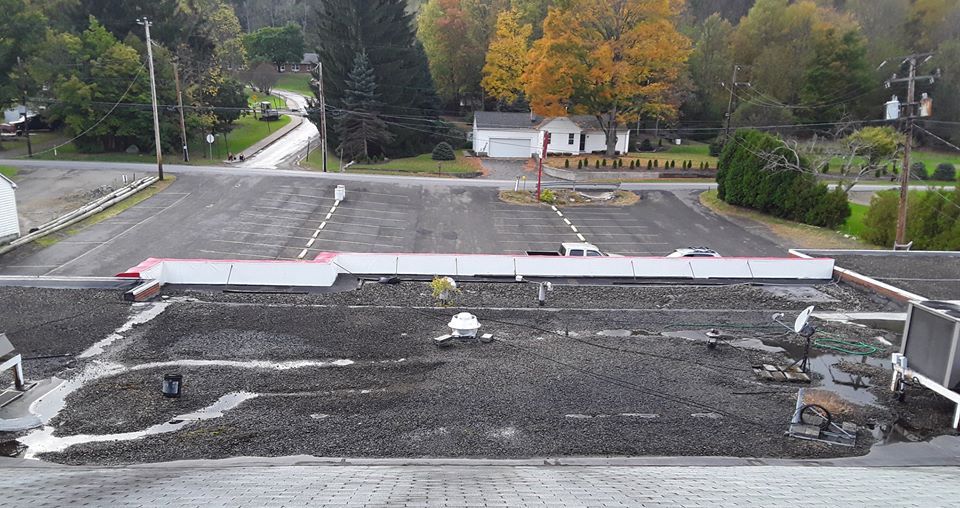 A view of a parking lot from the top of a building.