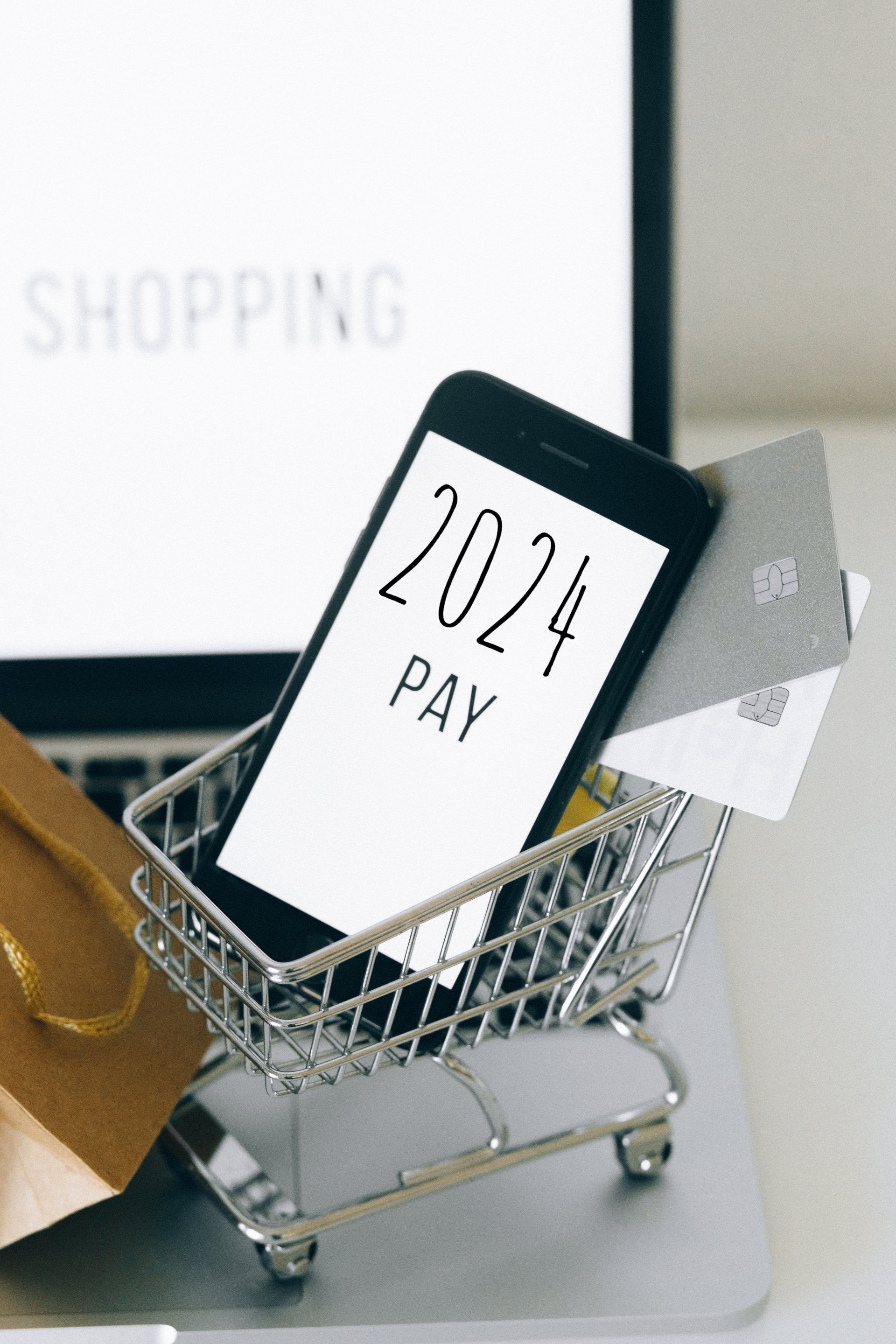 a shopping cart with a cell phone in it that says 2024 pay