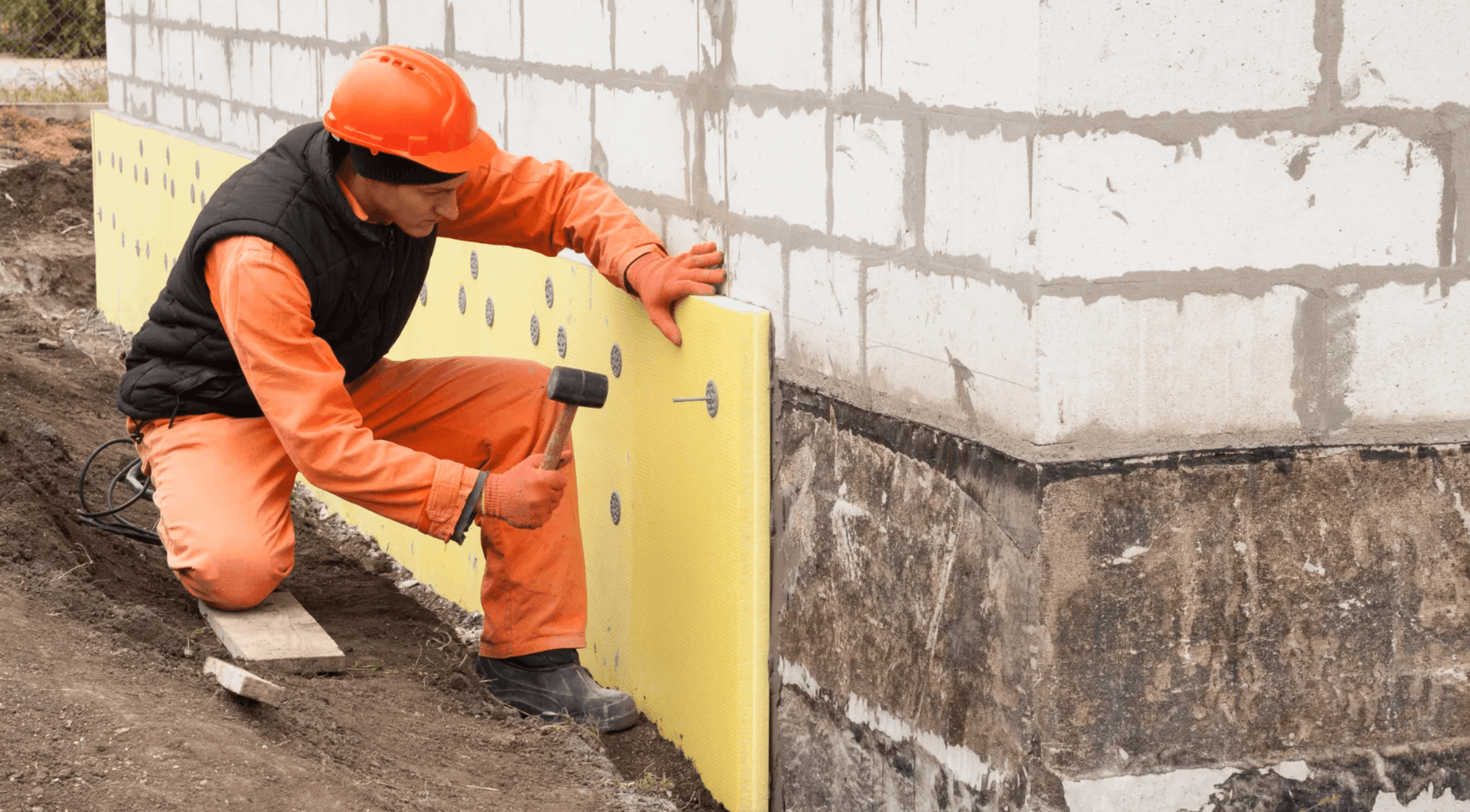 Professional contractor repairing a basement foundation