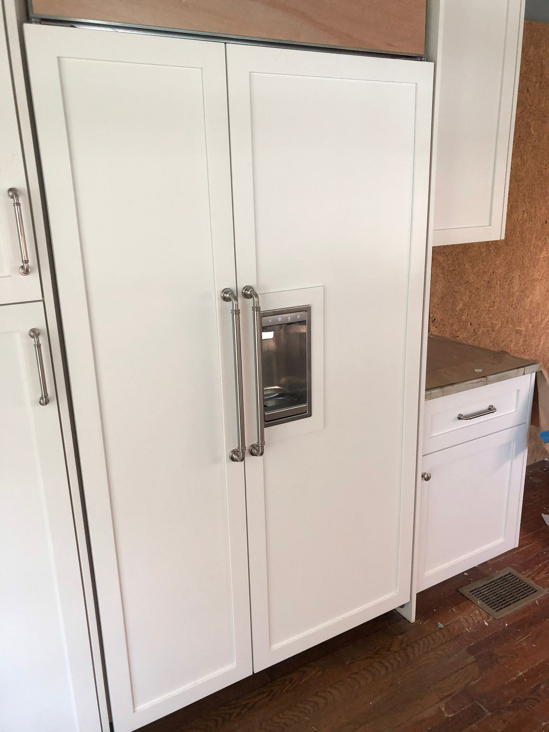 A kitchen with blue cabinets , a sink , and a dishwasher.