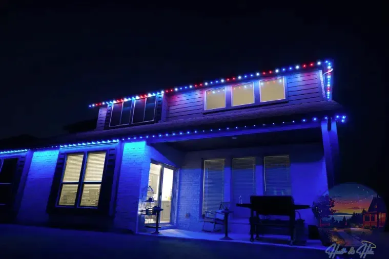 House exterior lit with blue and red Christmas lights against a dark night sky.