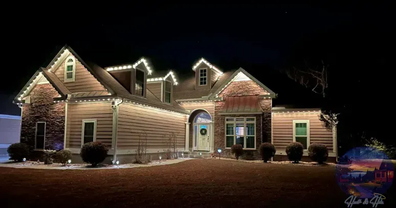 House decorated with white Christmas lights at night.