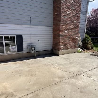 There is a brick chimney on the side of the house.