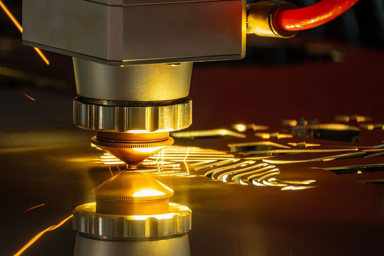 Laser cutter cutting metal, sparks flying, focused beam, industrial setting.