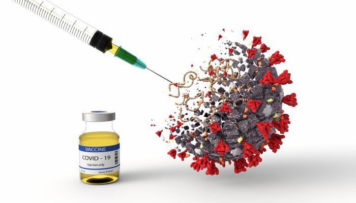 Coronavirus being injected with syringe, with vaccine bottle next to it.