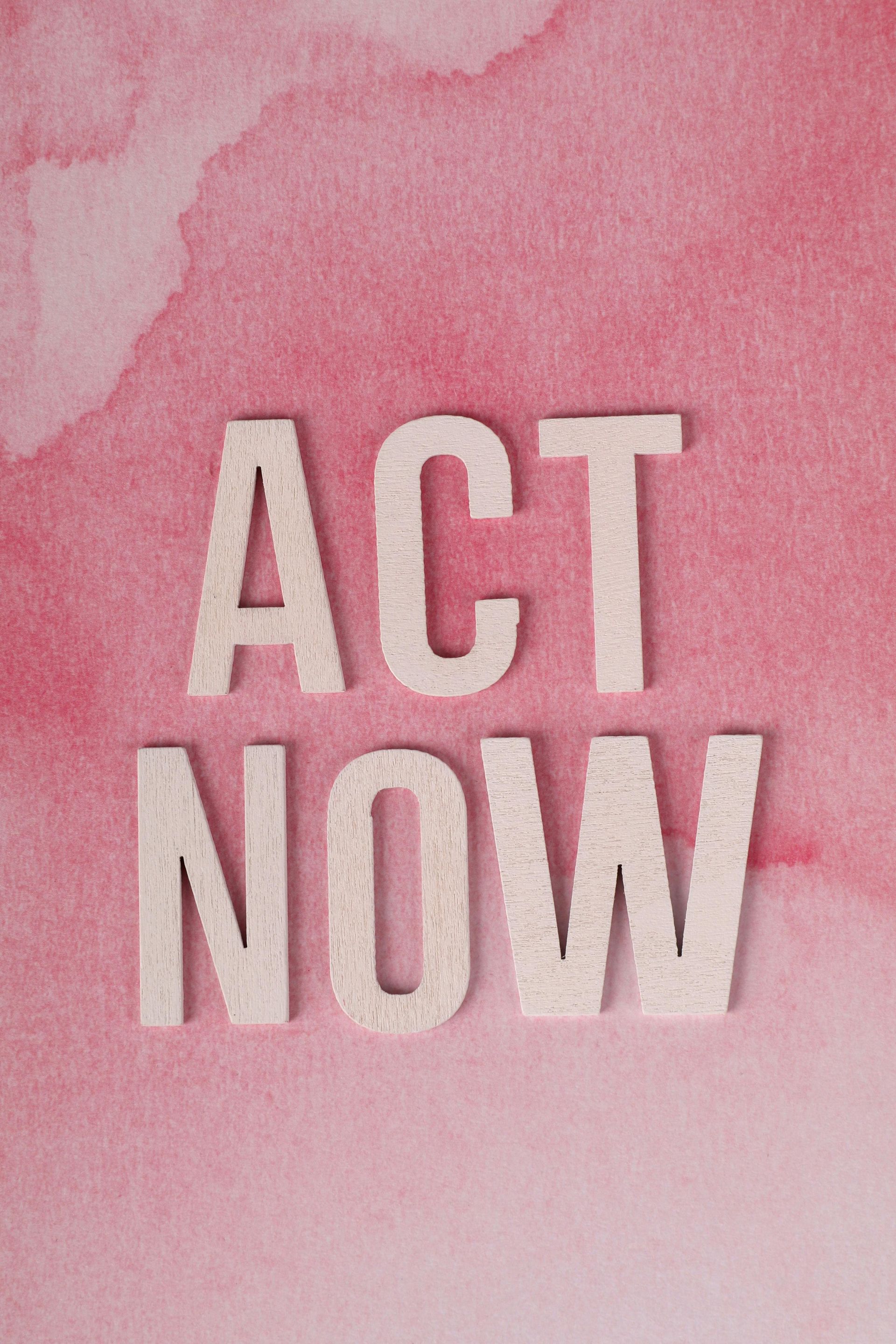 On a background of pink, ACT NOW in pale pink