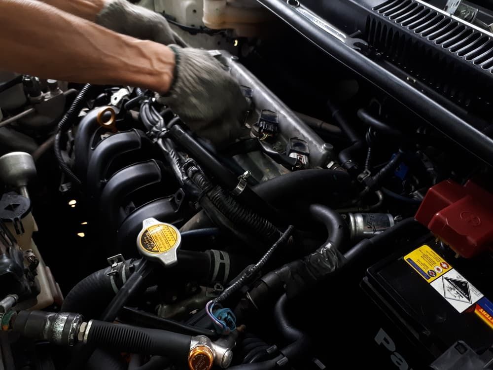 A Person is Working on a Car Engine With a Wrench — Aspire Diesel In Duaringa, QLD