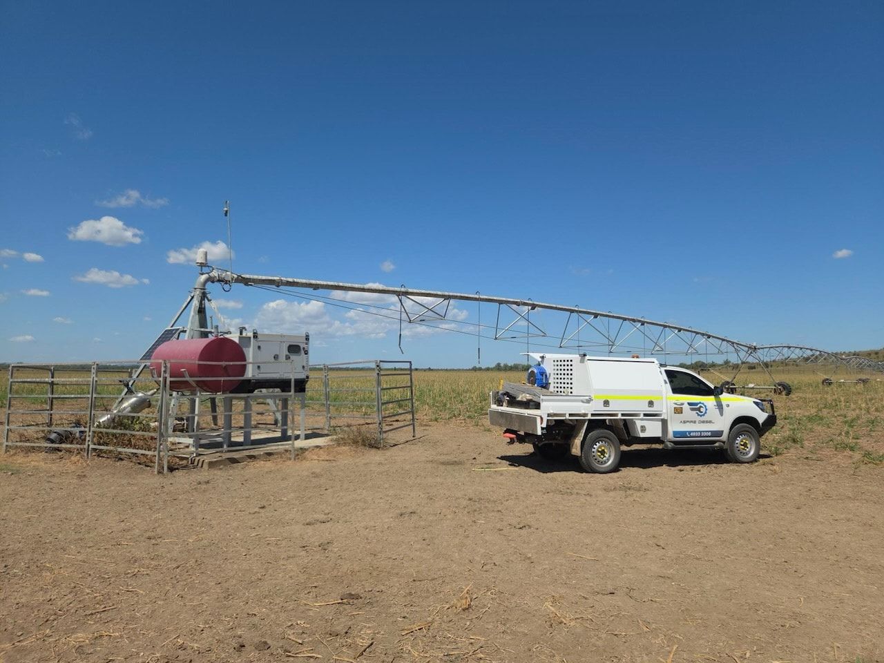 Utility Truck Beside a Red Tank and Long Irrigation Pipe — Aspire Diesel In Gracemere, QLD