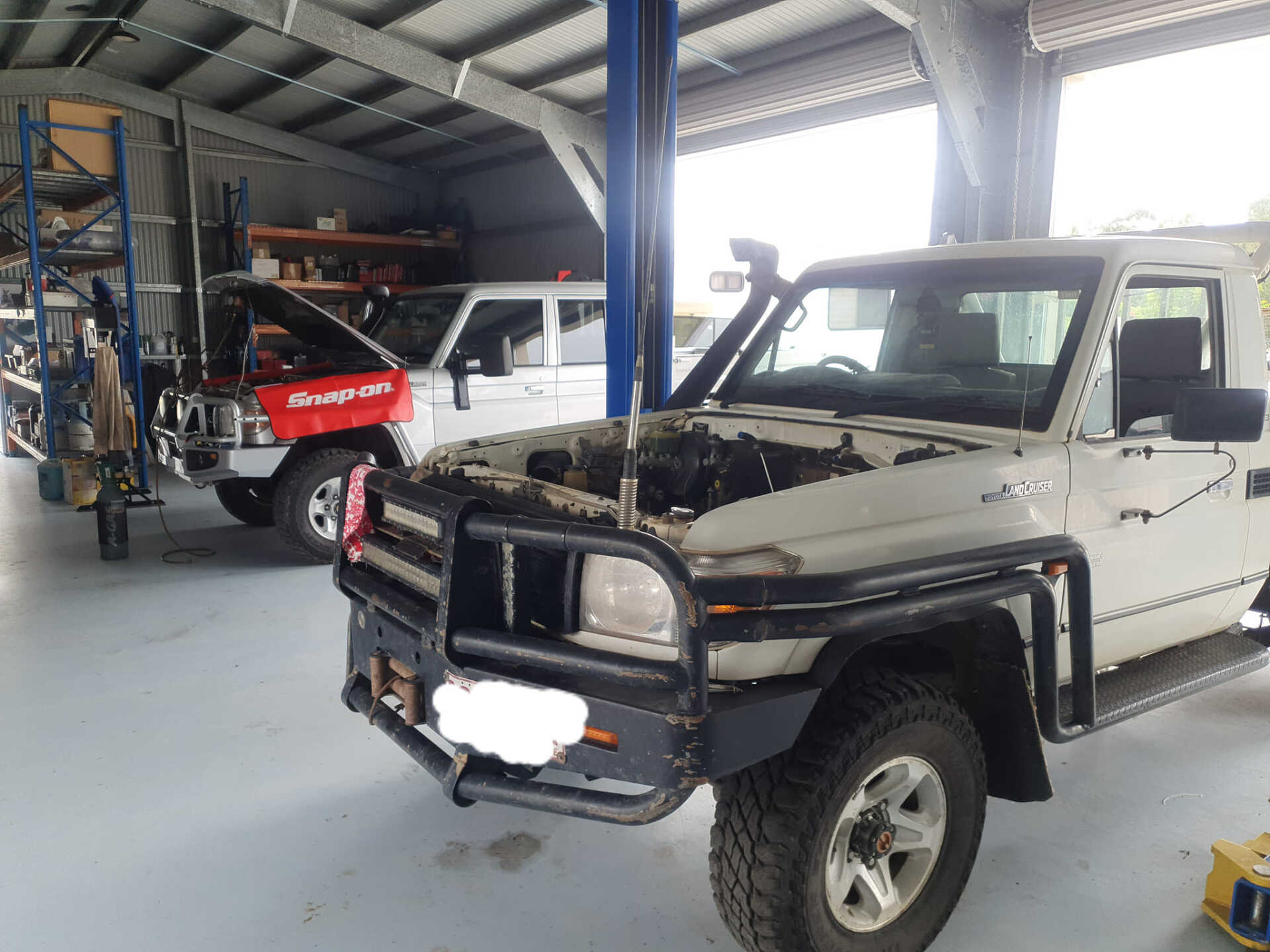 A White Truck With The Hood Up Is Parked In A Garage — Aspire Diesel In Gracemere, QLD