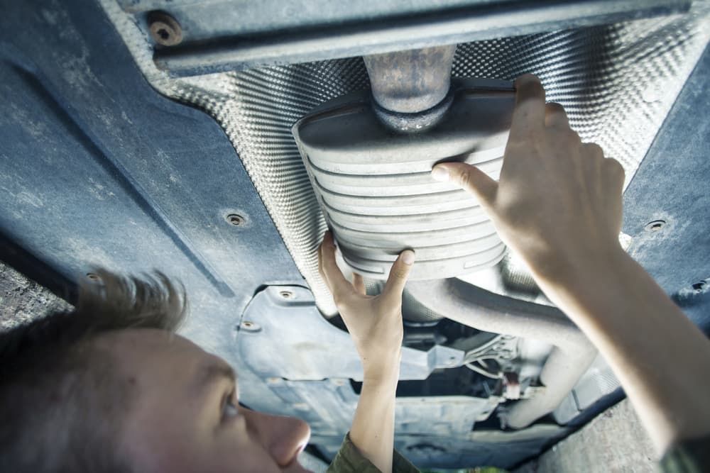 A Man is Working on the Underside of a Car — Aspire Diesel In Dingo, QLD