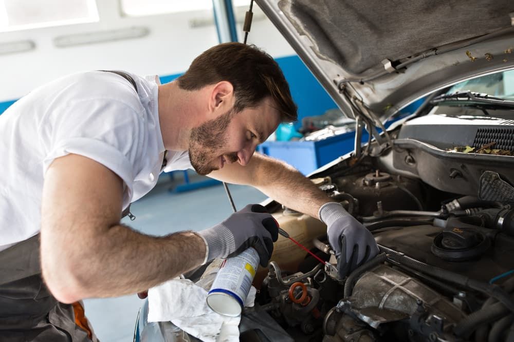 A Person is Working on a Car Engine With a Wrench — Aspire Diesel In Duaringa, QLD