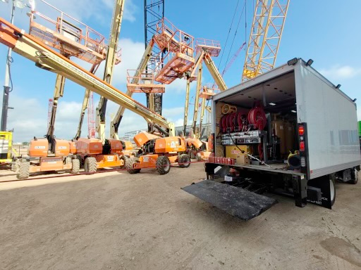 A white truck is parked in front of a construction site