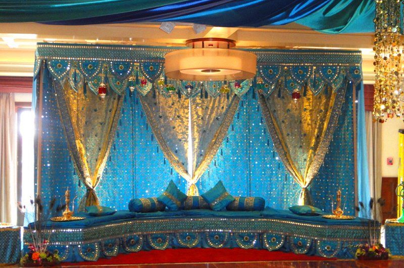 Wedding celebration Indian style stage with blue and gold decor