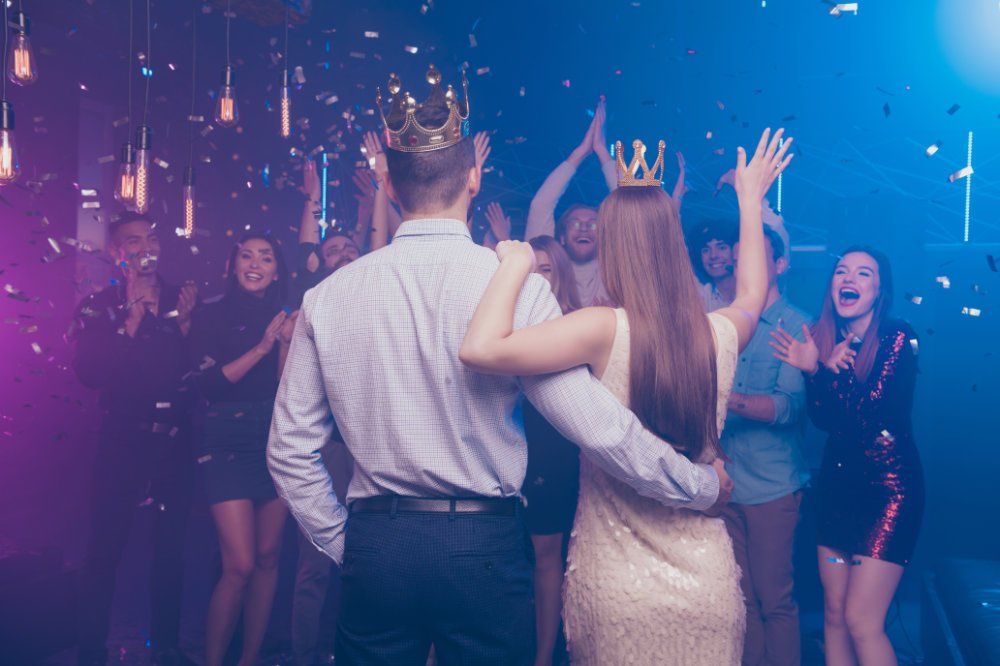 Student events King and Queen prom theme showing a couple from behind walking into event