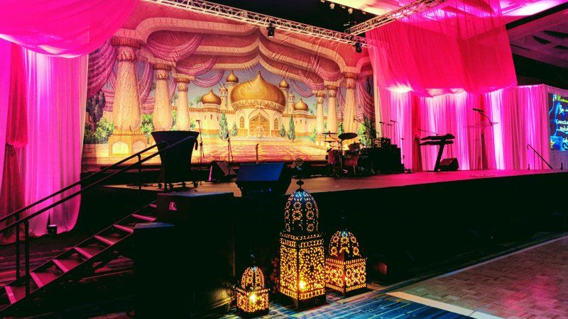 Galas and fundraising event Moroccan themed black tie stage setup with lanterns
