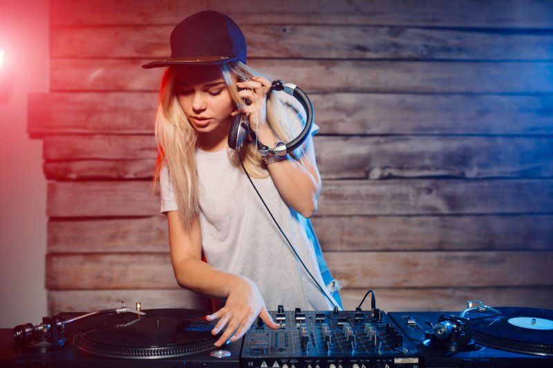 Teen birthday party DJ setting up music for play