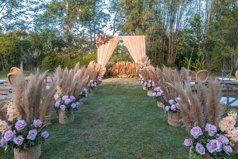 Wedding celebration rustic styled outdoor aisle arrangement with flowers