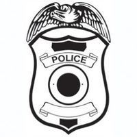 Police badge with eagle, scroll, and circular center.