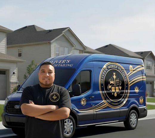 Man standing in front of a blue branded van in a suburban driveway