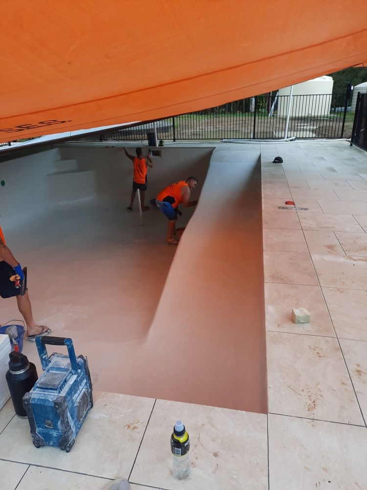 A Group Of People Are Working On A Swimming Pool — CJB Pools in Cooroy, QLD
