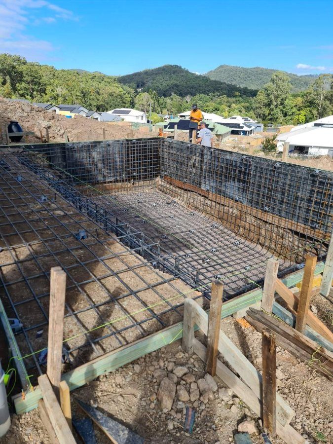 A Swimming Pool Is Being Built In The Middle Of A Dirt Field — CJB Pools in Gympie, QLD
