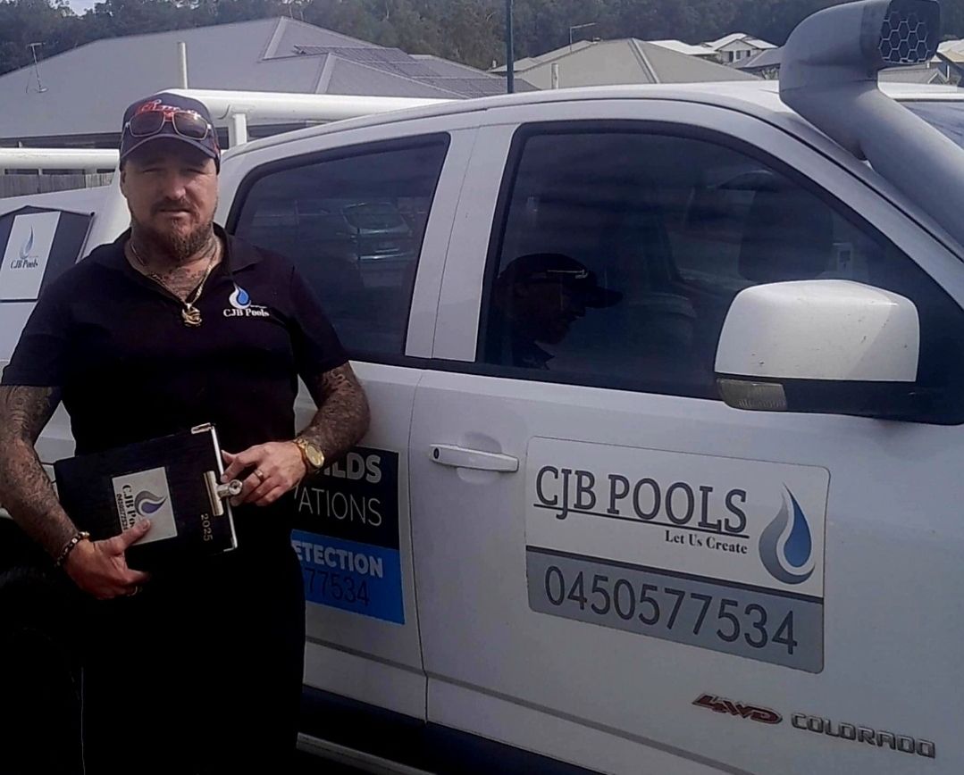 A Wooden Fence Is Being Built In Front Of A House — CJB Pools in Gympie, QLD