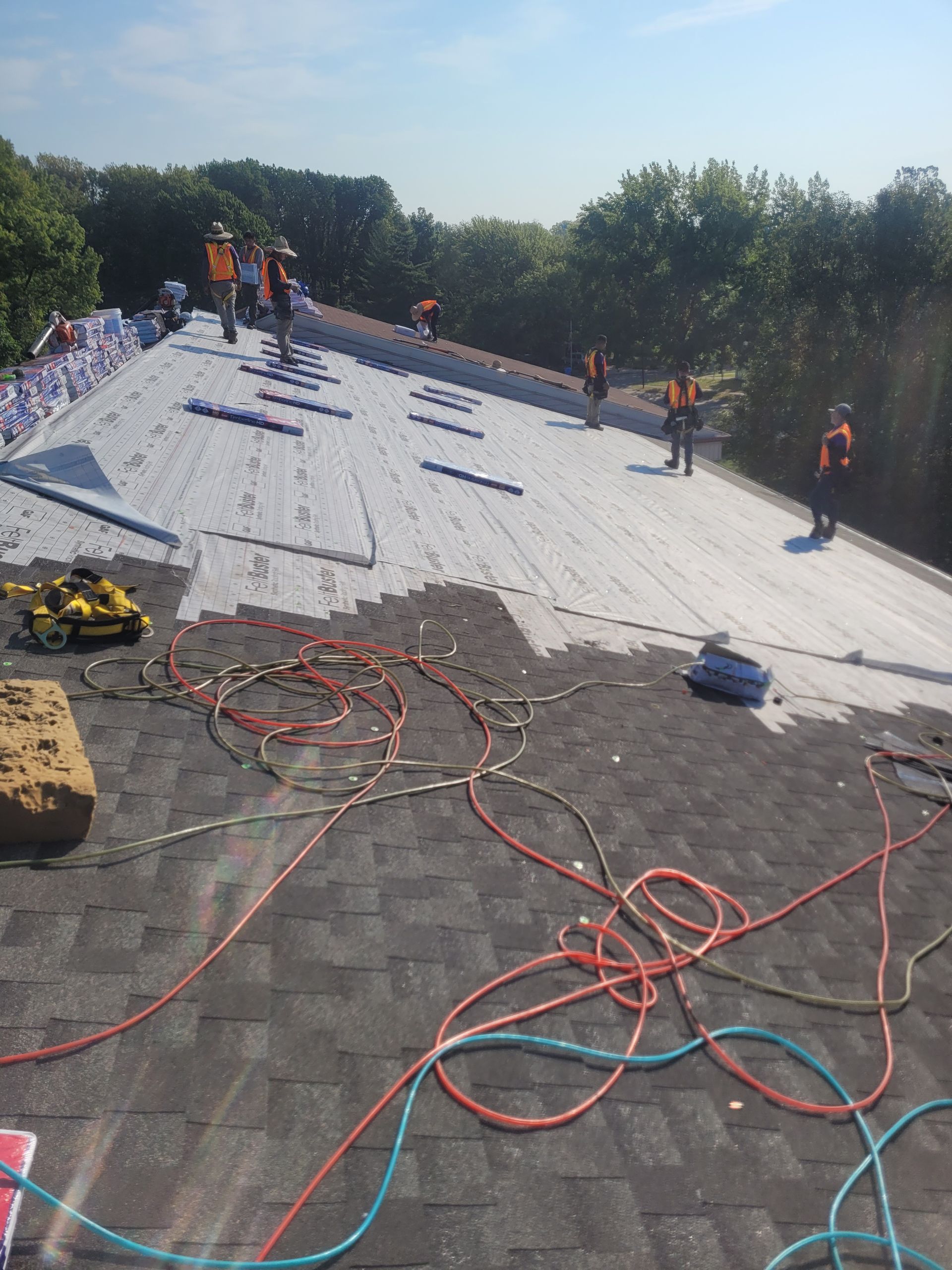 A group of people are working on a roof.