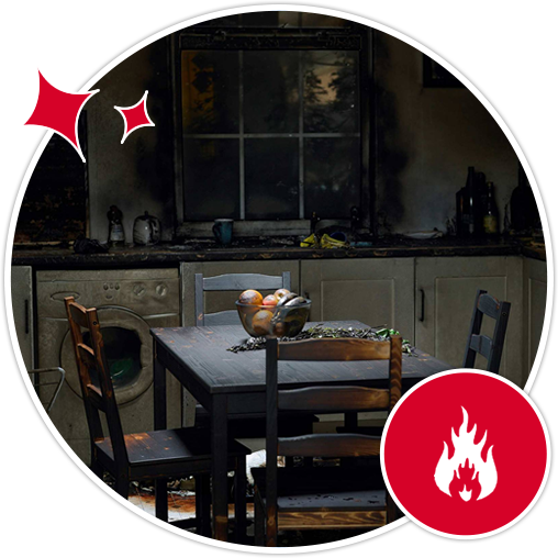 A kitchen showing smoke damage, with a table, chairs, and a red circular overlay featuring a white flame icon.