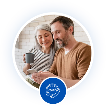A man and woman smiling while looking at a smartphone together, with a 24/7 customer support icon below them.