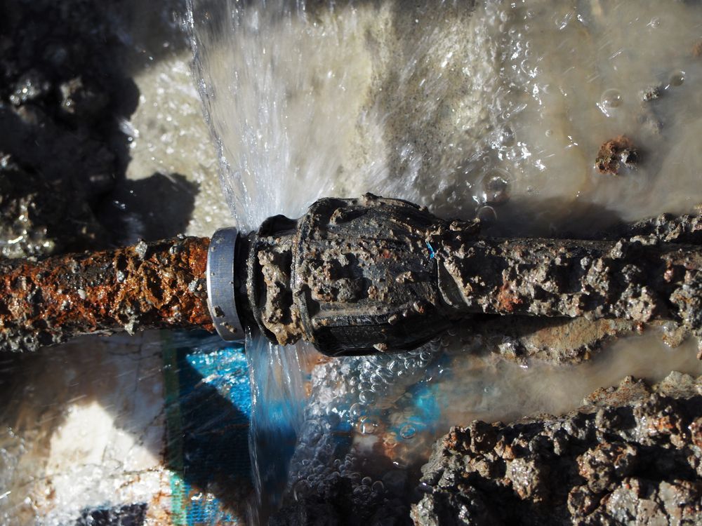 Rusted Pipe With a Leak, Spraying Water — Ian Stanley Plumbing In Avoca, QLD