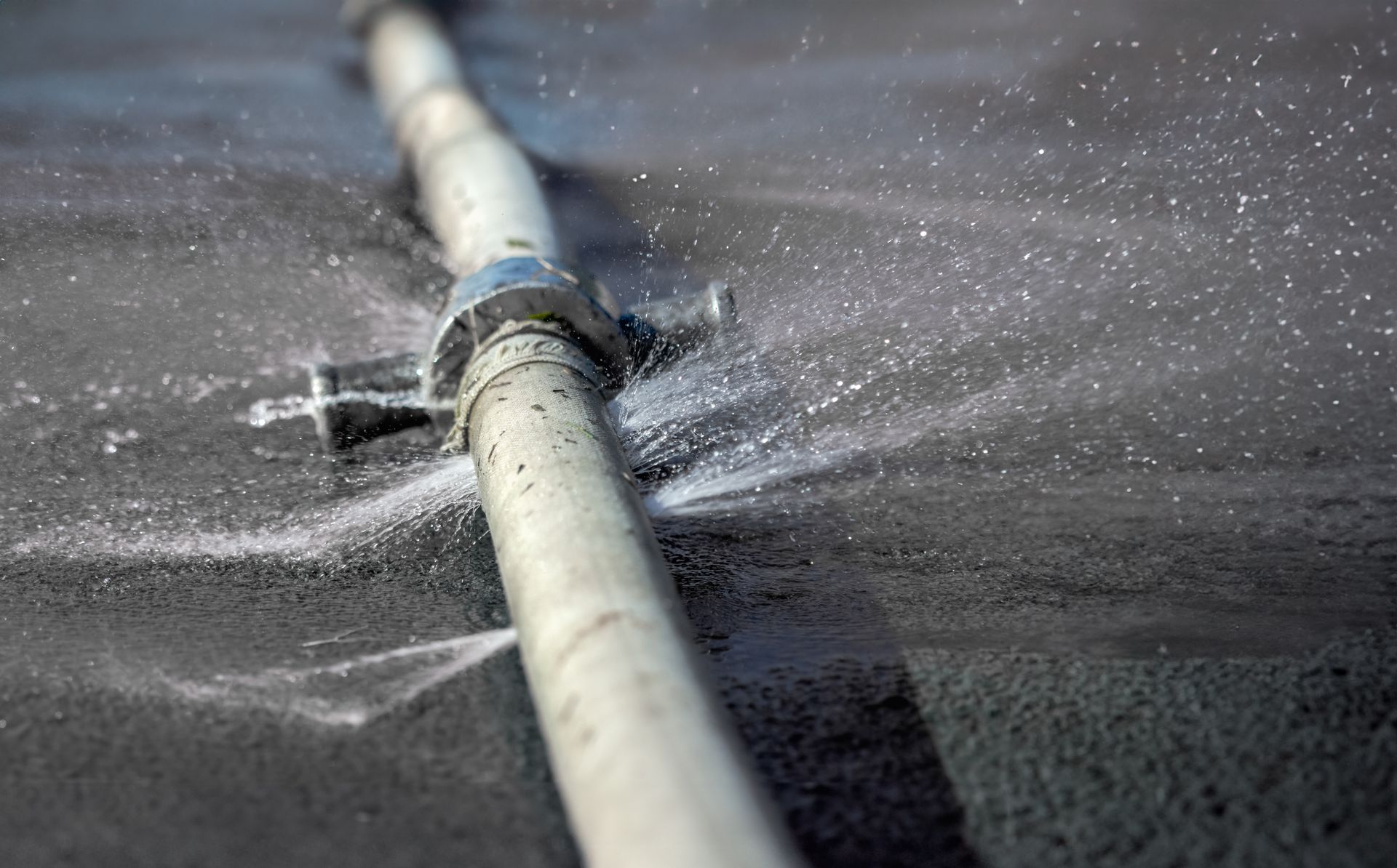 Water Spurting From a Broken Pipe on a Dark Surface — Ian Stanley Plumbing In Avoca, QLD