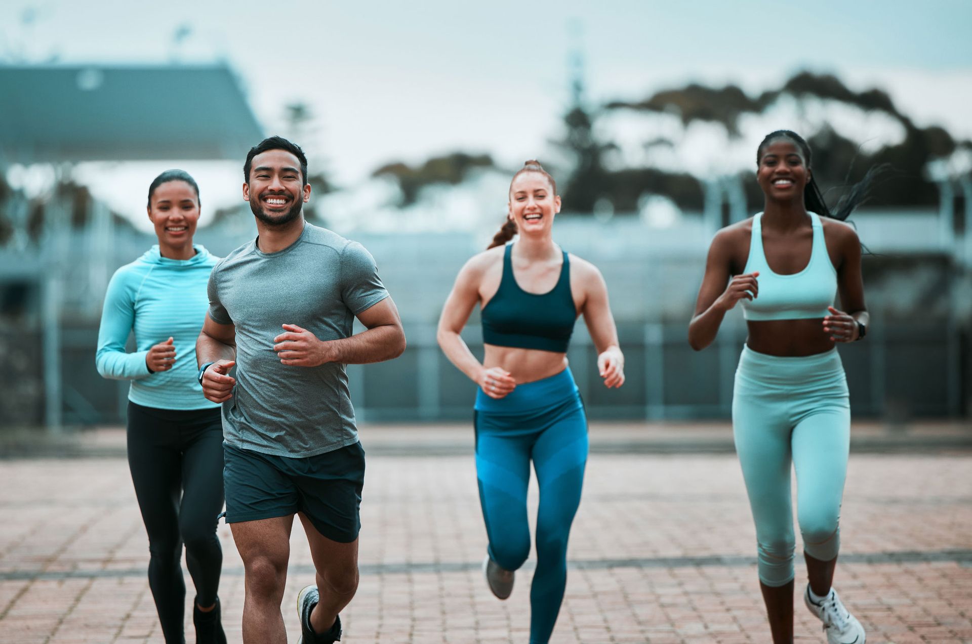 A group of people are running on a sidewalk.