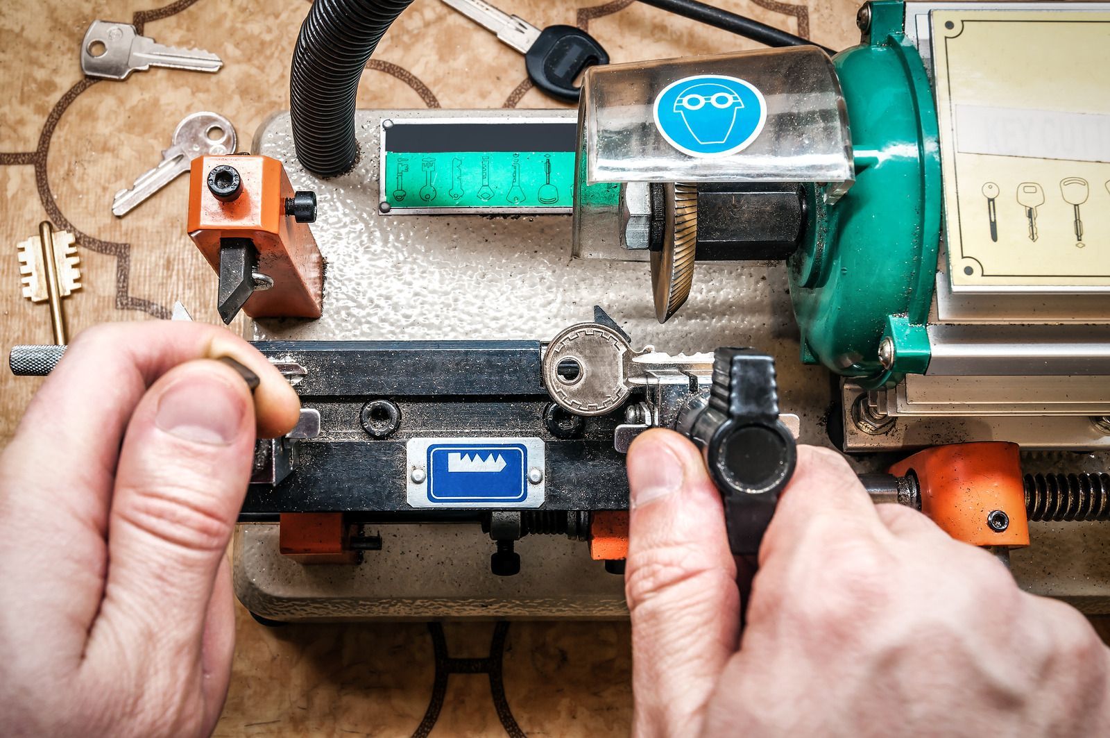 A person is cutting a key with a machine.