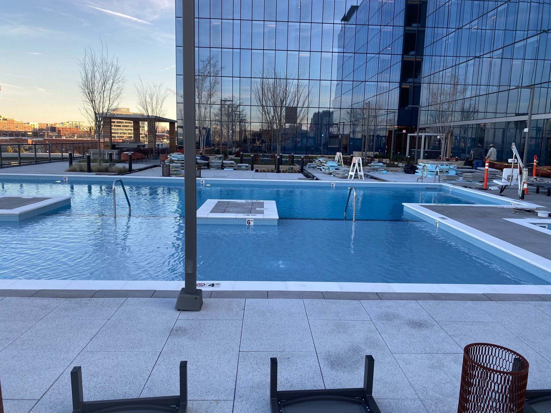 A large swimming pool with a large building in the background