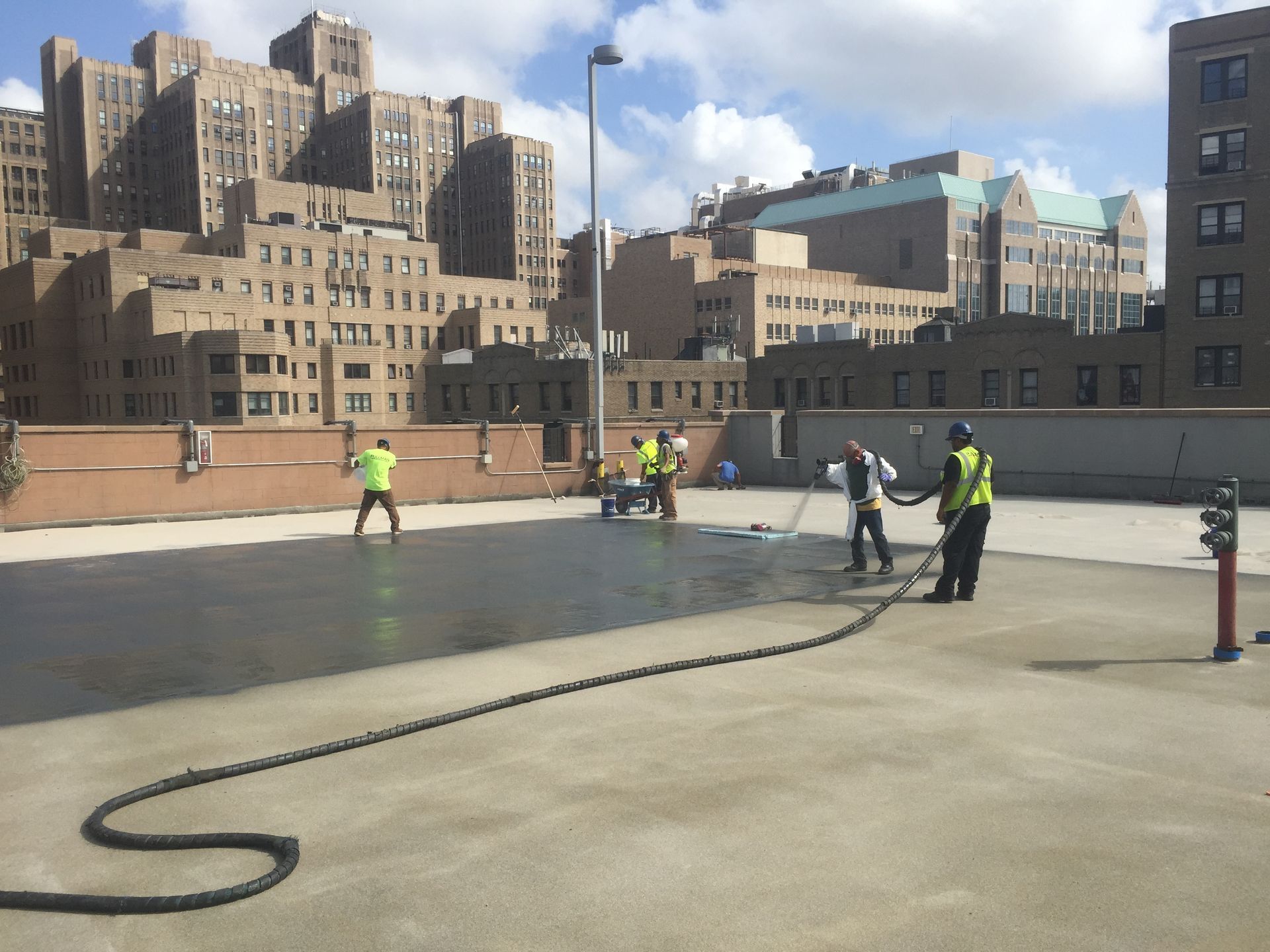A group of construction workers are working on a rooftop