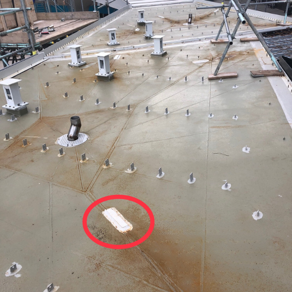 A roof with a red circle around a white object