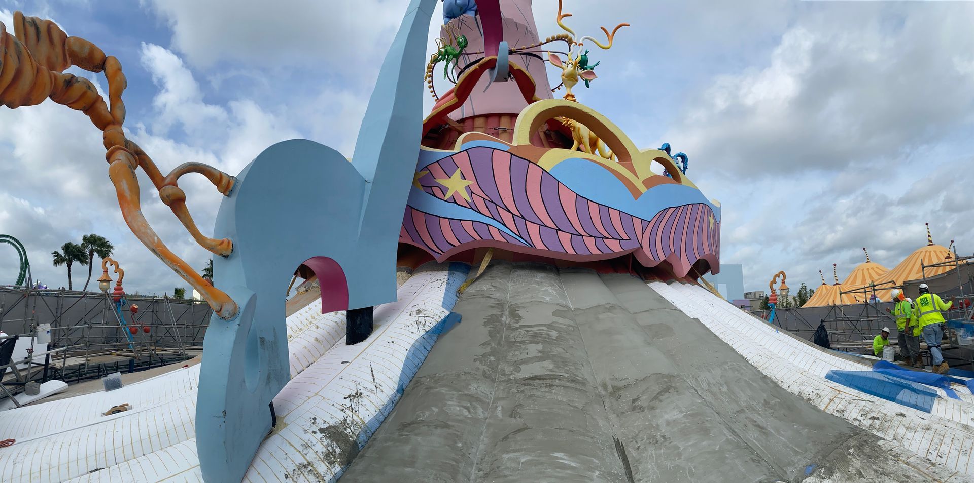 A colorful sculpture is being built in a park