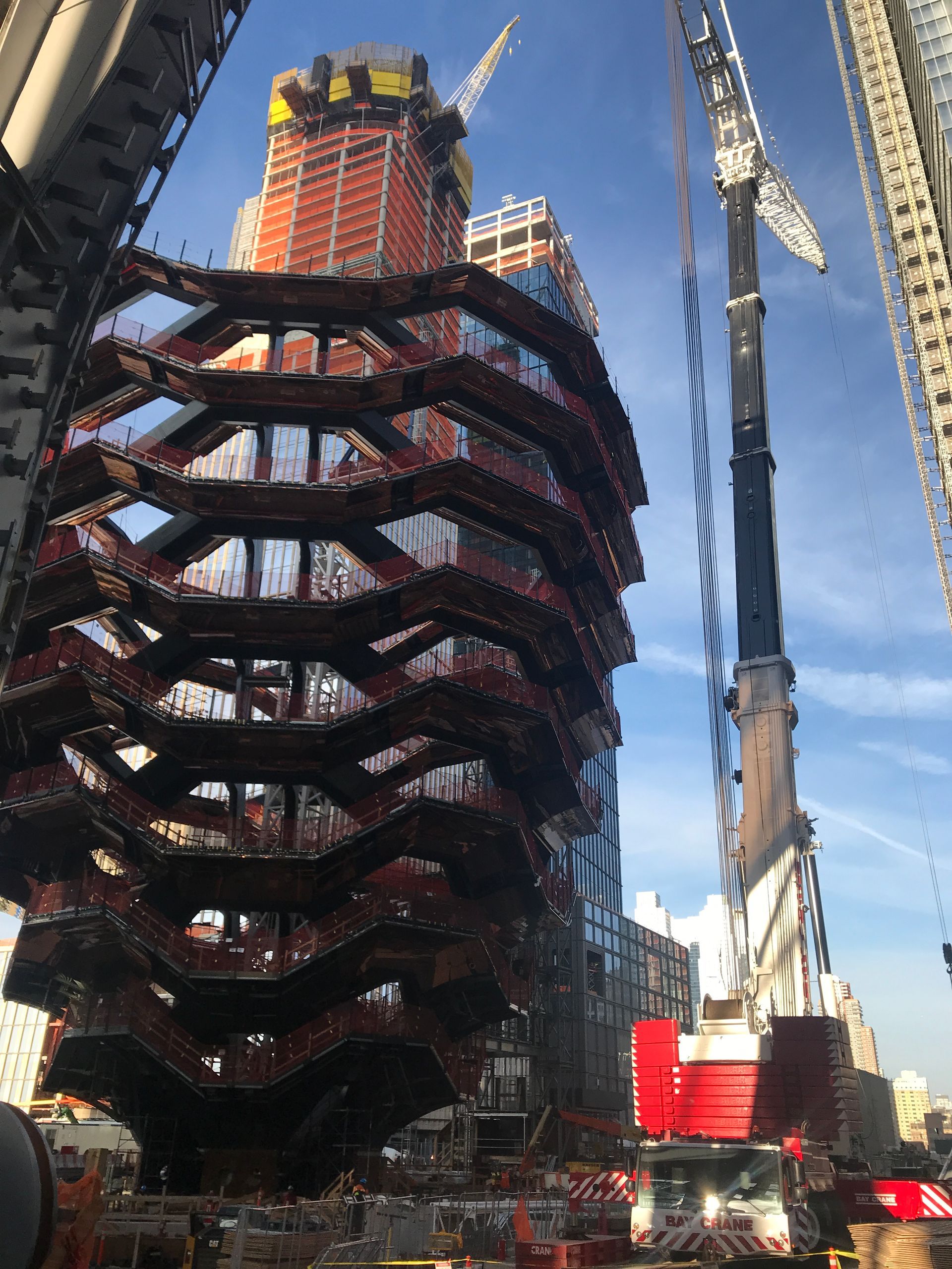 A large building under construction with a crane in the foreground