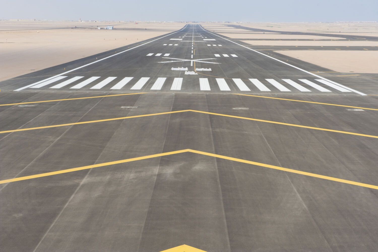 A Runway With A Yellow Arrow Pointing To The Right — Spraywayz Linemarking Pty Ltd In Booral, QLD