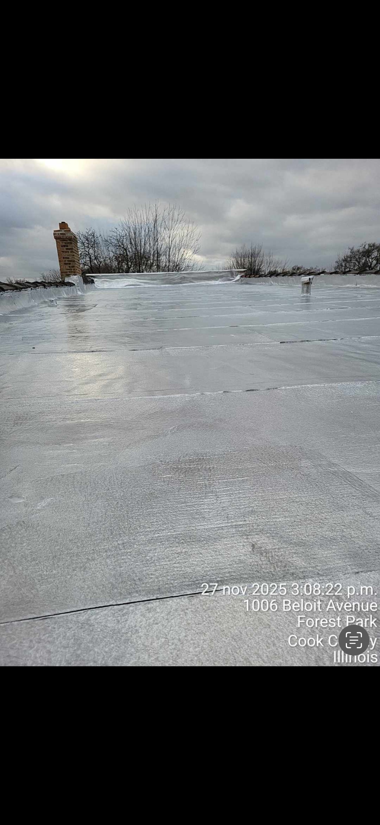 Frozen lakeside with a person standing at left under a cloudy winter sky